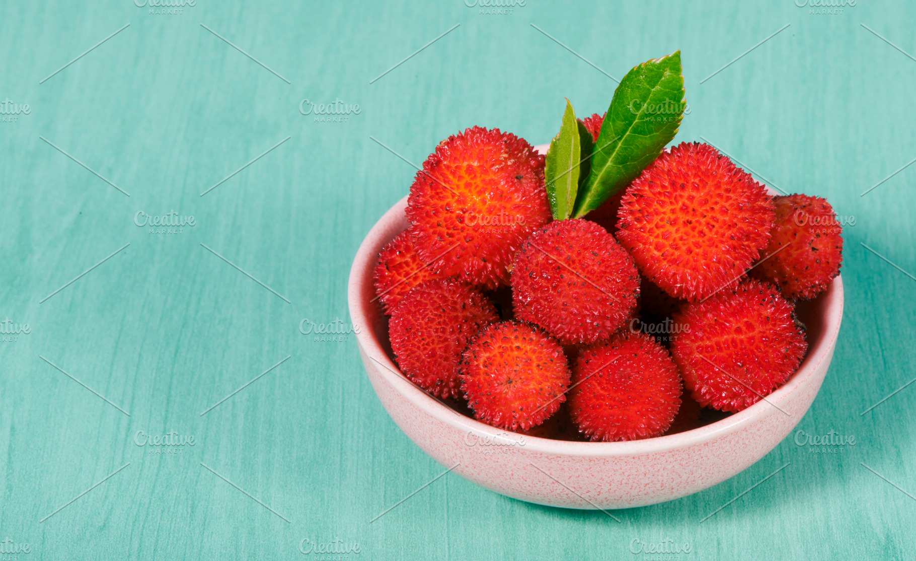 bowl with some spiky Arbutus unedo berries, a Photo by Nito