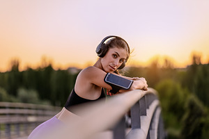 Young woman with headphones resting, a Sports & Recreation Photo by Perpis