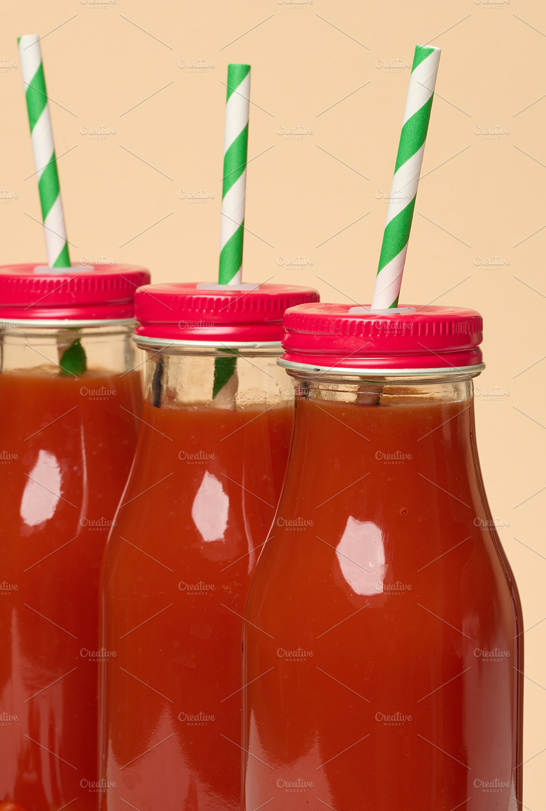 Glass bottles with tomato juice with red caps., a Food & Drink Photo by ndanko