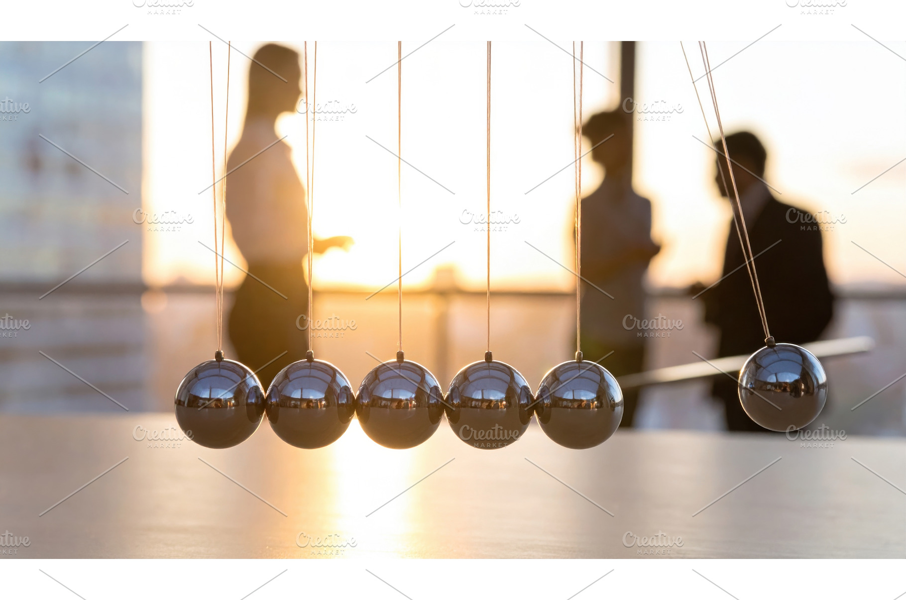 Newton's cradle in the foreground, a Business Photo by Igor Tichonow