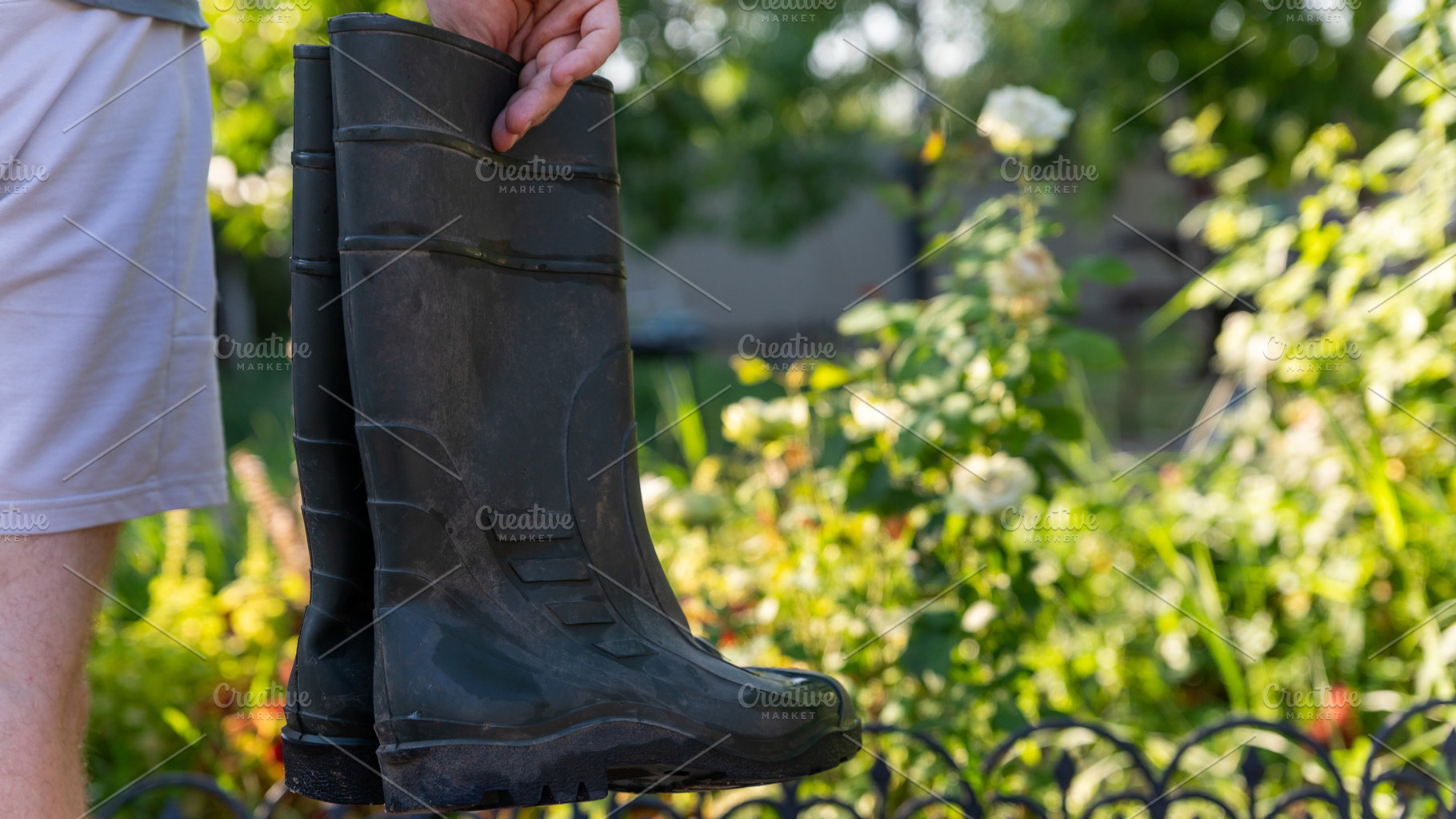 Hand Holding Garden Boots, a Person Photo by Ales Munt