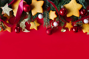Christmas background with gingerbread cookies, fir branches, red