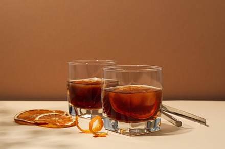 Concept of delicious alcohol drink, Whiskey with orange, a Food & Drink Photo by AtlasStudio PRO