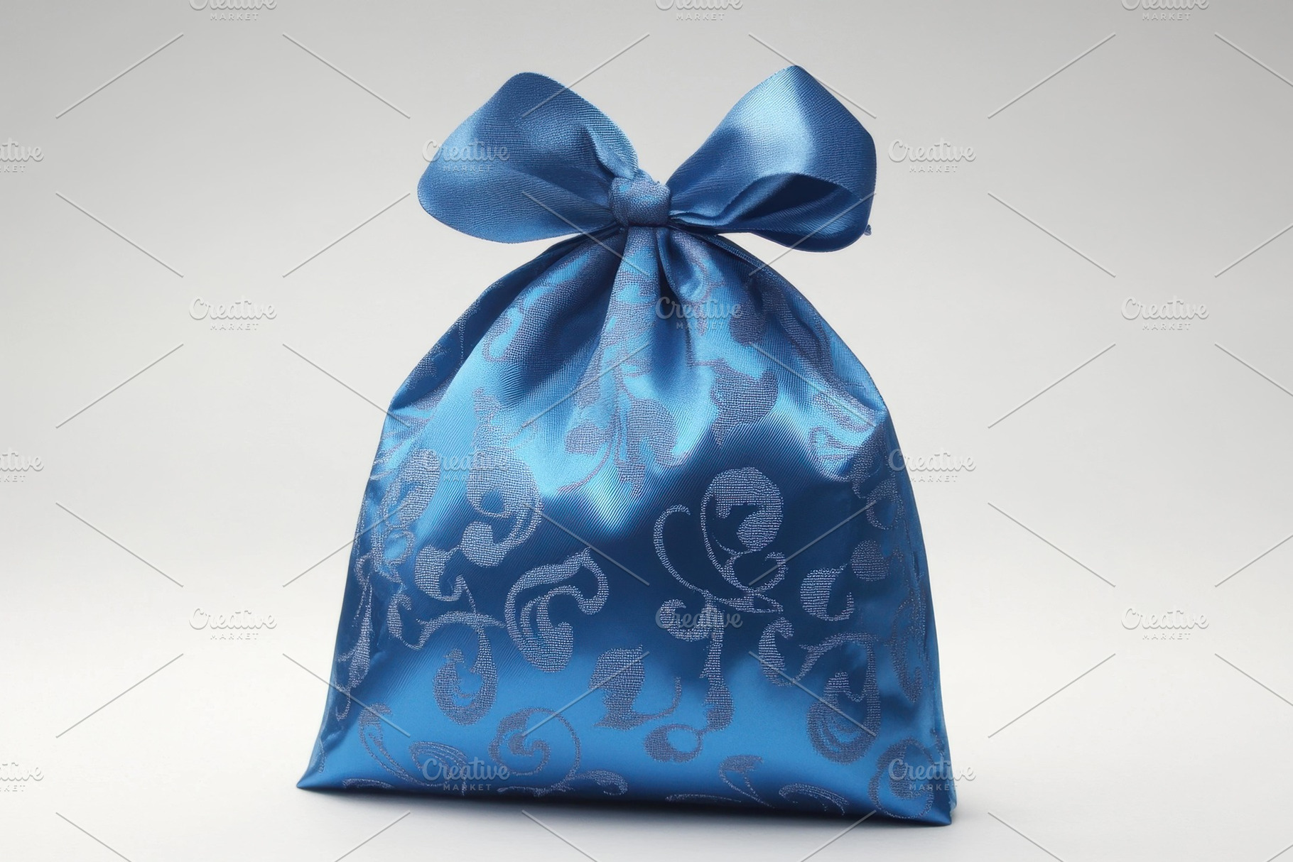 Beautiful blue satin gift pouch with, a Photo by Tanuart