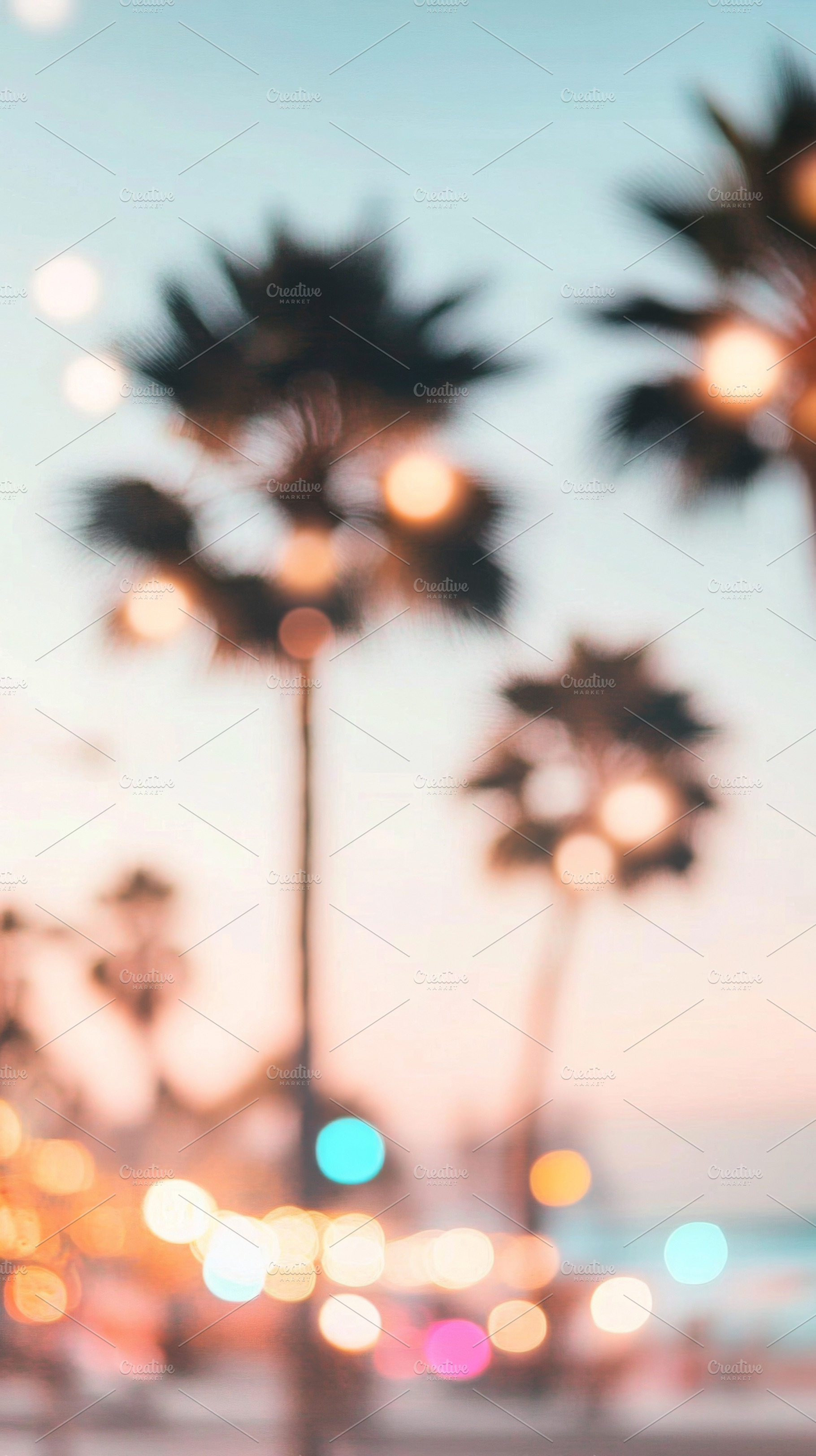 Blurry out-of-focus palm trees at su, a Photo by Dvoevnore photos