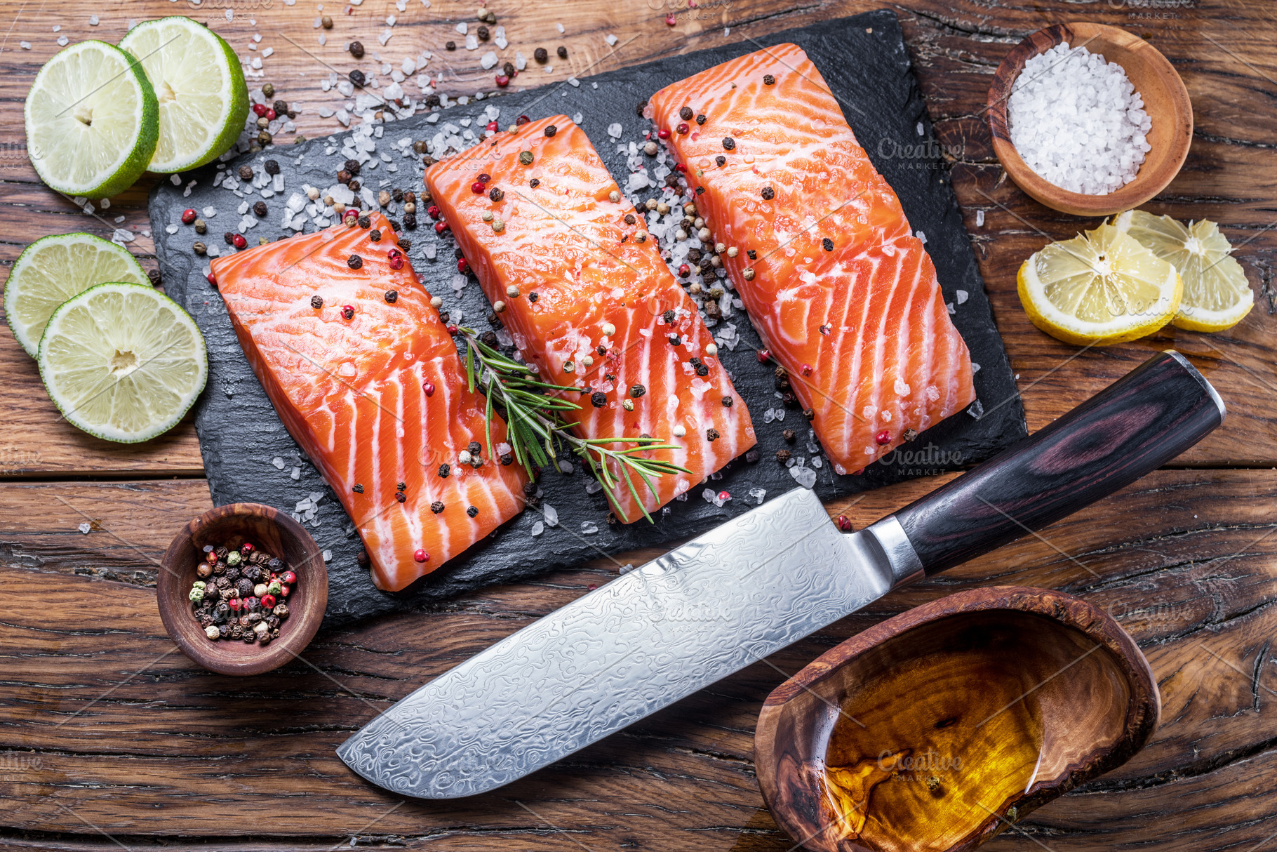 Fresh salmon fillets on black cuttin, a Photo by Volff