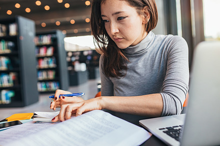 Young woman studying on a book, a School & Education Photo by Jacob Lund