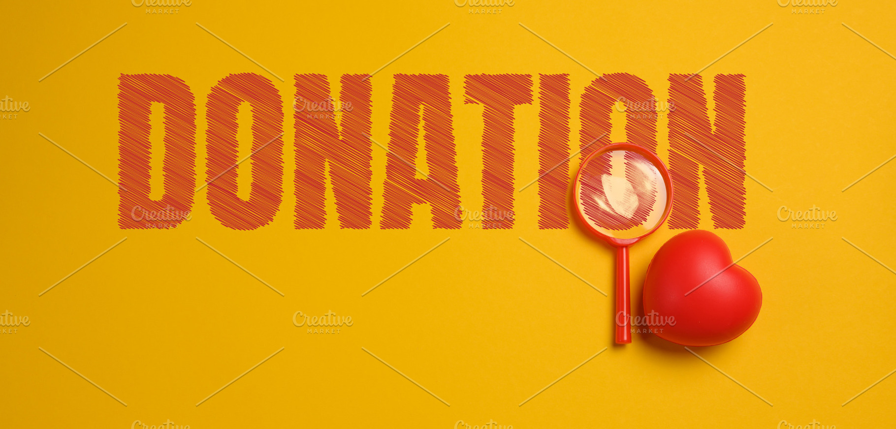 A composition with the word DONATION, a red magnifying glass,, a Photo by ndanko