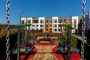 Modern playground in residential complex courtyard, an Industrial Photo by Photostock