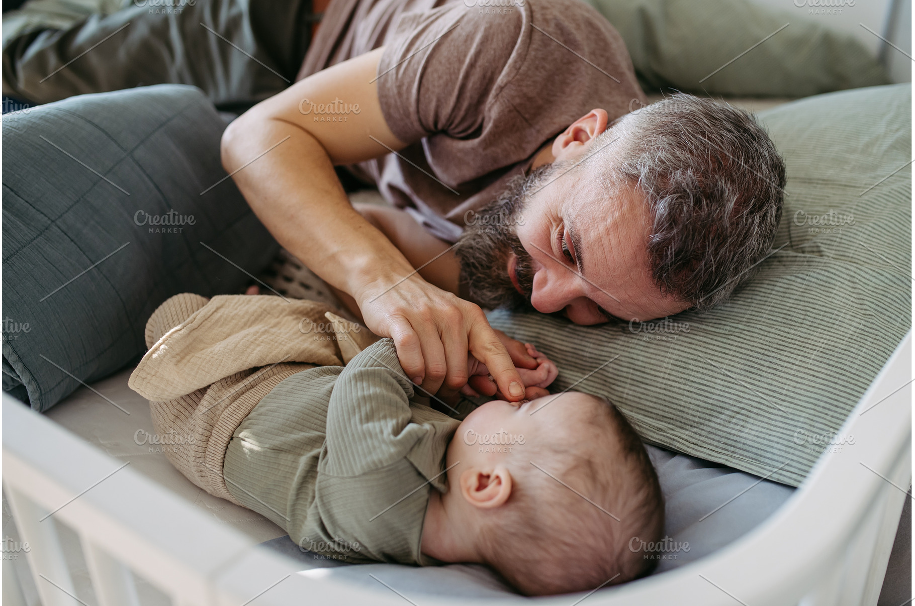 Father putting the baby to sleep, a Person Photo by HalfPoint
