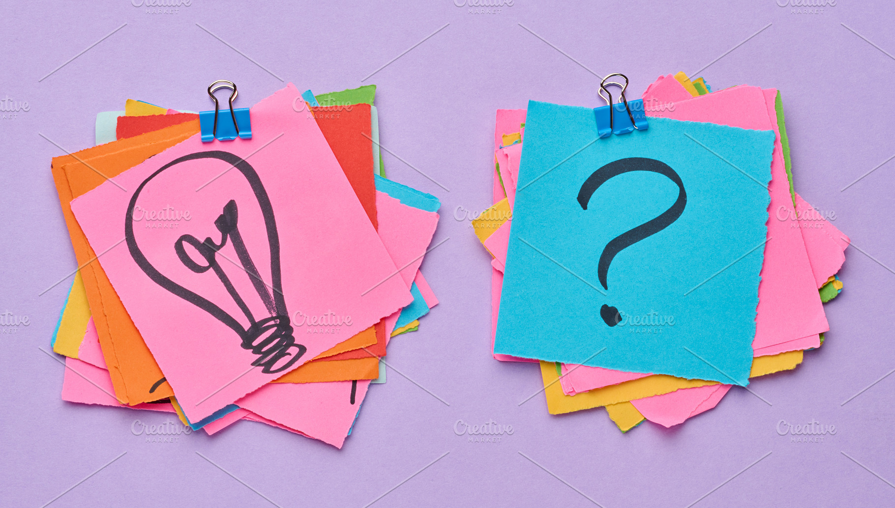 Two stacks of multi-colored paper notes with drawings of a light, a Business Photo by ndanko