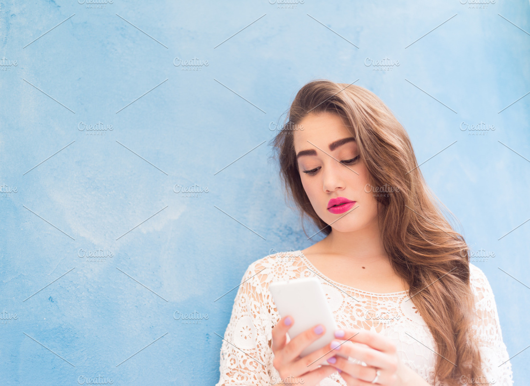 Cute girl playing with her phone stock photo containing arabic and attractive, a Person Photo by harodominguez