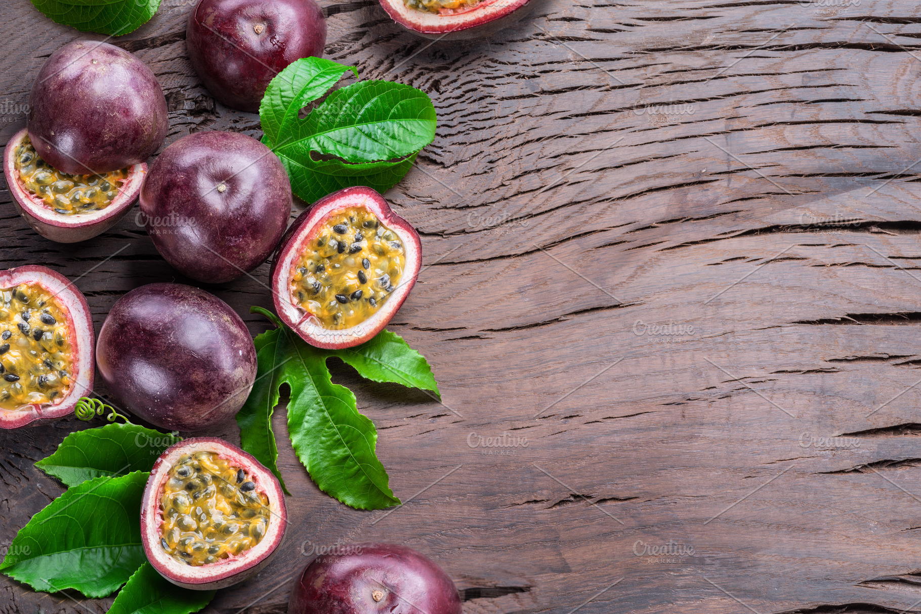 Dark purple passion fruits and it's half with seedly interior on, a Food & Drink Photo by Volff
