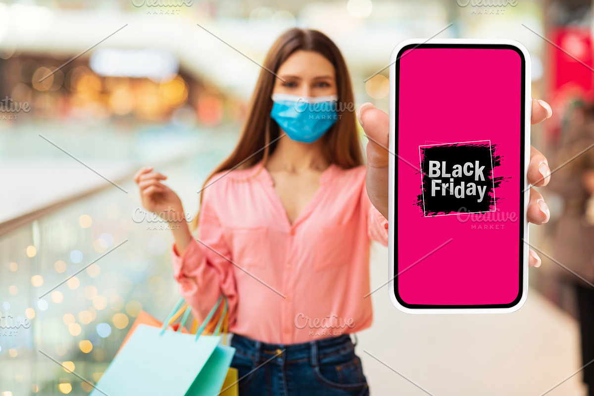 Lady Showing Phone Advertising Black Friday Shopping Offer In Mall, a Photo by Prostock-Studio (Photo 3 of 3)