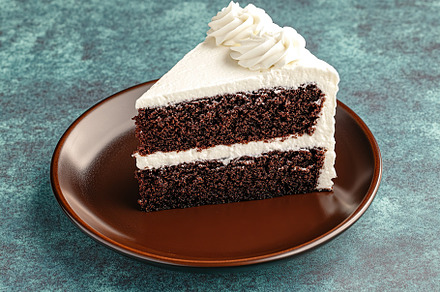 Delicious piece of cake with frosting cream, a Food & Drink Photo by AlyaAnd