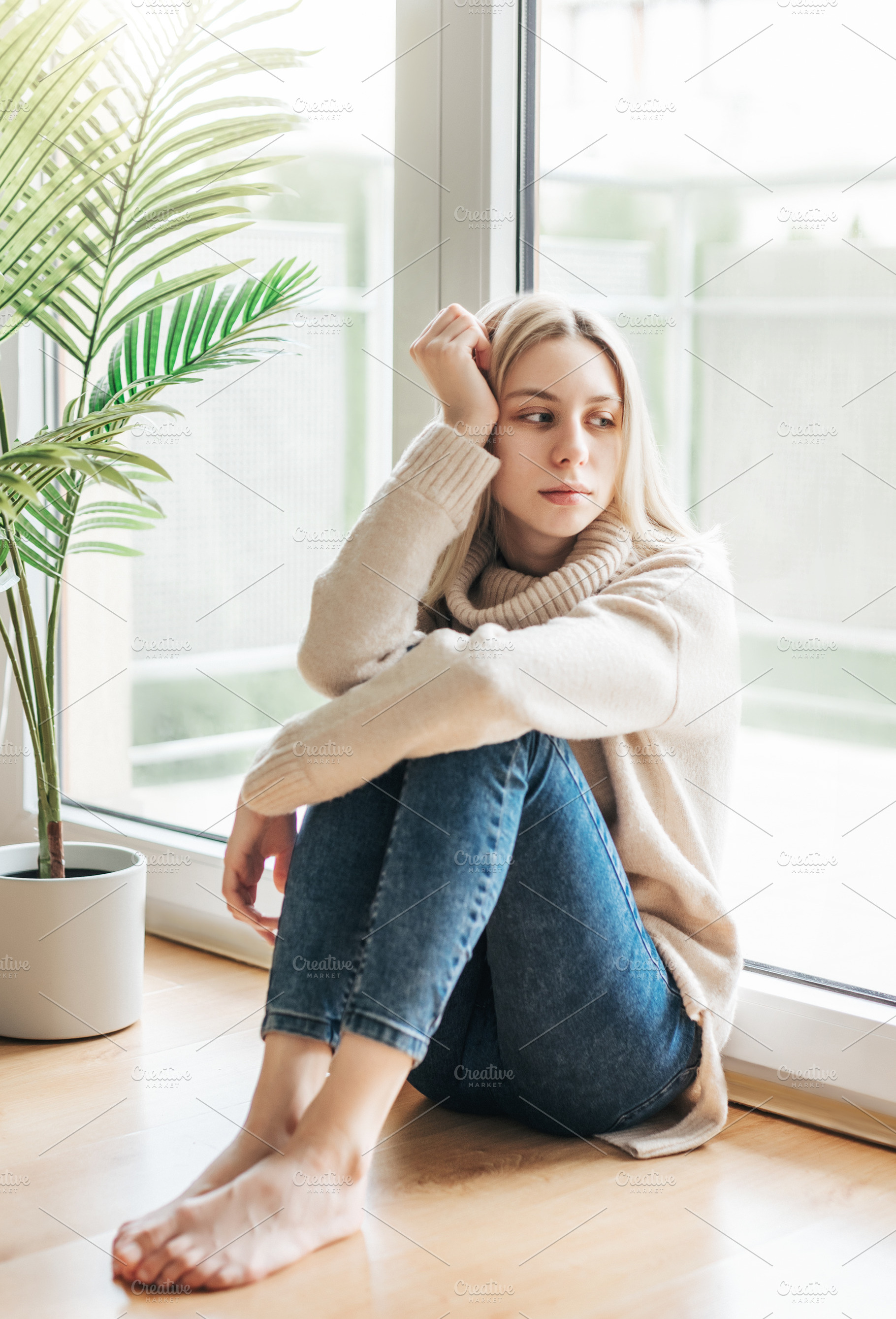 Sad girl near window thinking about something, a Person Photo by Olena Rudo