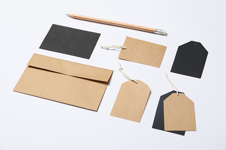 Envelope, tags and pencil on white background, mockup, a Business Photo by AtlasStudio