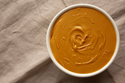Organic Peanut Butter in a Bowl, top view. Flat lay, overhead.