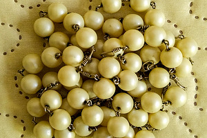 Rosary bead on embroidered fabric, an Arts & Entertainment Photo by DanFLCreativo