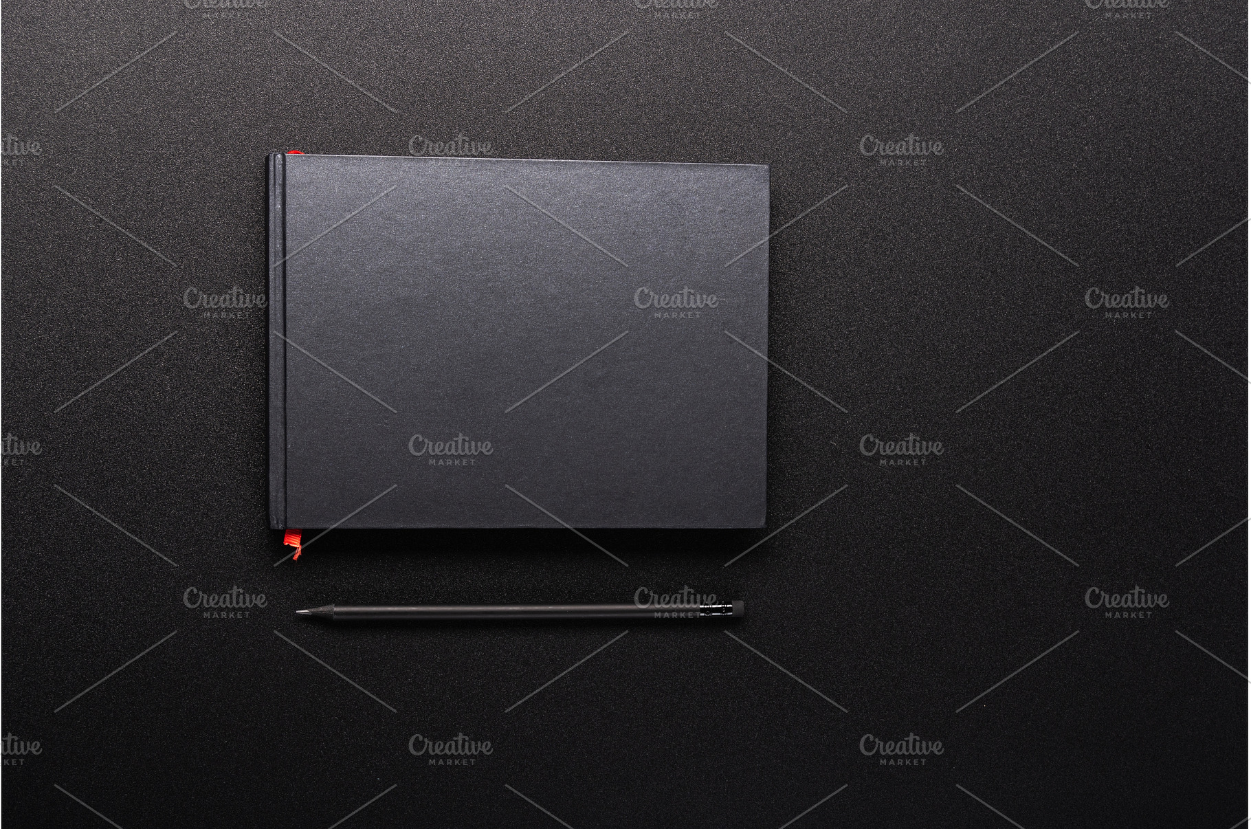 Minimalist black notebook with a red, a Background Photo by Stockphoto by vzwer