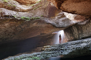 Hidden waterfall into canyon containing canyon, waterfall, and river