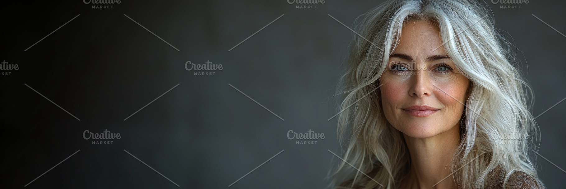 Confident mature woman with long silver wavy hair smiling gently, a Person Photo by José Manuel Gelpi