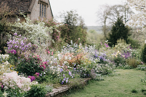English cottage stone house with blooming spring garden and colo, a Photo by Studio ANNA
