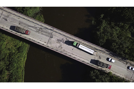 Top view of passing vehicles on, a Transportation Photo by Media Whale Stock