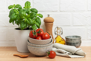 Fresh cherry tomatoes and basil creating a vibrant culinary scen, a Food & Drink Photo by Olena Rudo
