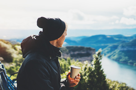 A cup of hot coffee in nature stock photo containing hands and holding