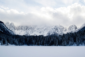 Frozen Lake with snowy mountains