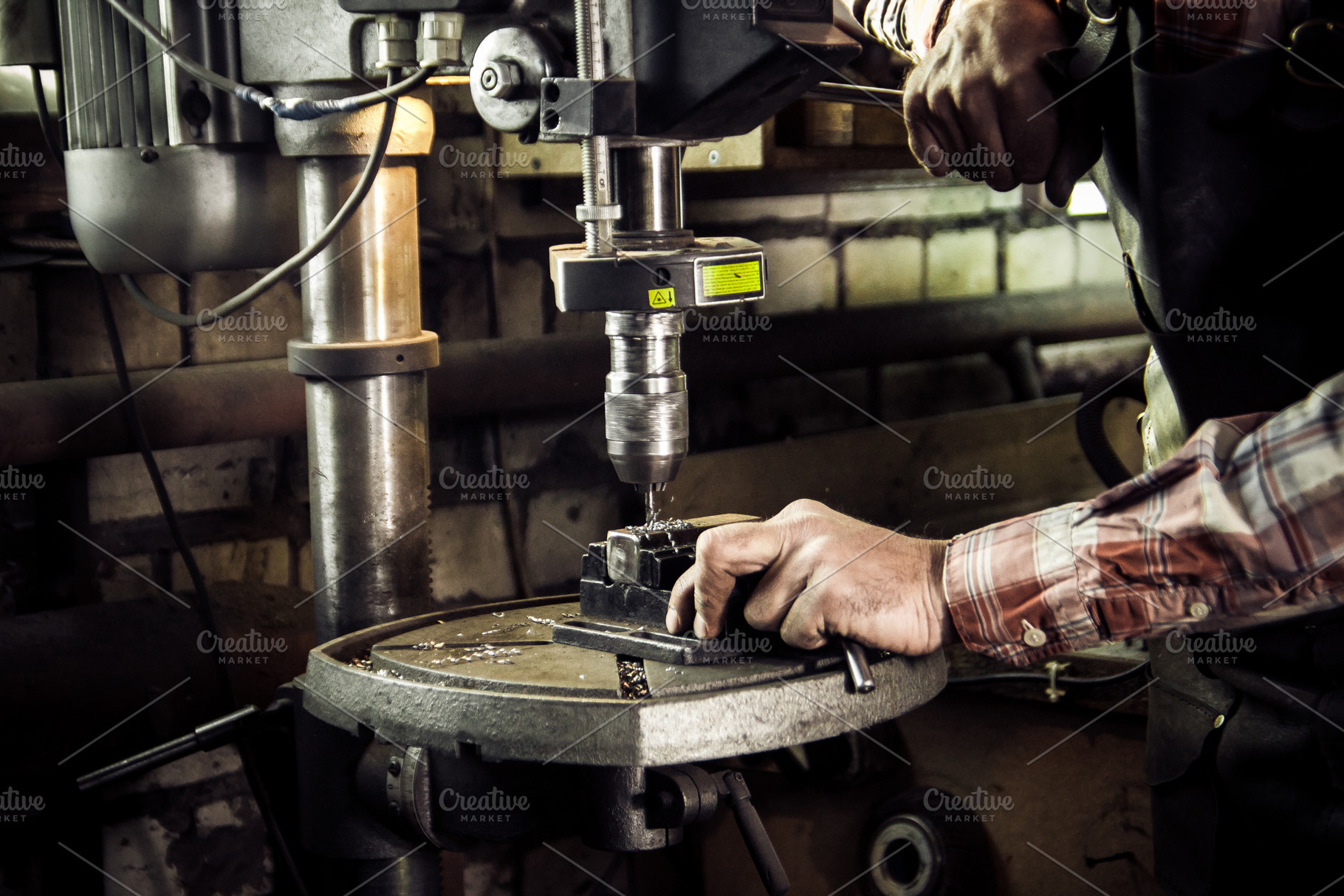 Blacksmith drills workpiece, small, a Person Photo by Barcelona_dreams