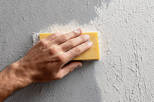 Hand sanding a textured wall surface, a Photo by Beautiful things