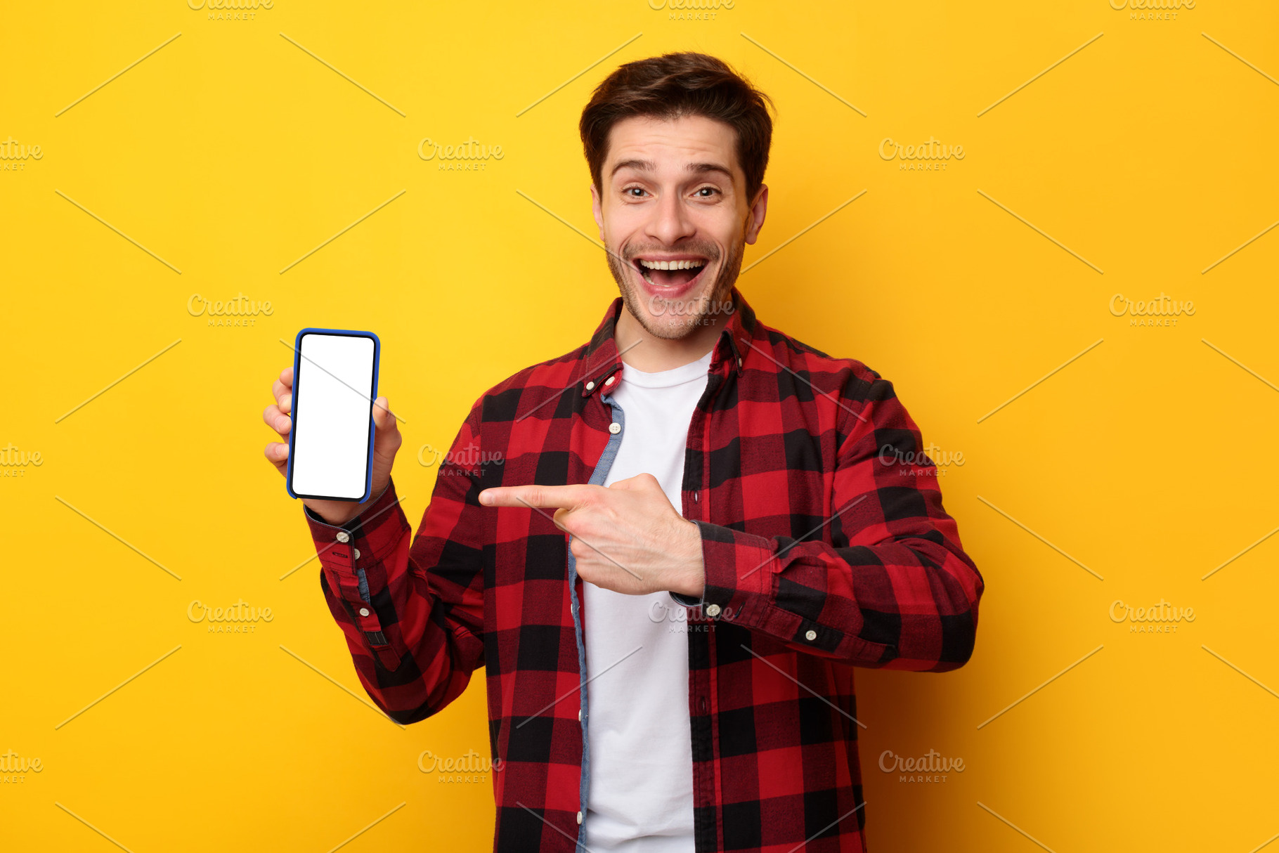 Man showing white empty smartphone screen and pointing finger, a Photo by Prostock-Studio