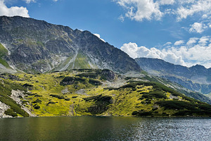 Scenic alpine lake in Zakopane, Poland with rugged mountains and bright blue sk, a Nature Photo by AS photostudio