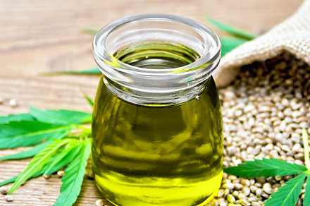 Oil hemp in jar with sheet containing hemp, cannabis, and grain