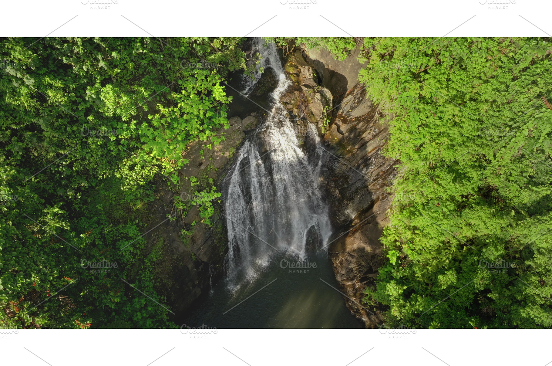 Waterfall cascading through lush, a Nature Photo by Goinyk
