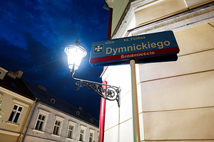 Street lamp and Dymnickiego sign in Rzeszow Poland during the evening, a Photo by AS photostudio