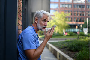 Doctor recording a voice message to, a Health & Medical Photo by HalfPoint