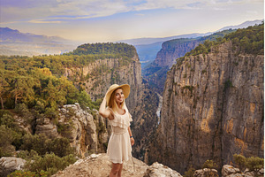 Tourist woman on the edge of a cliff