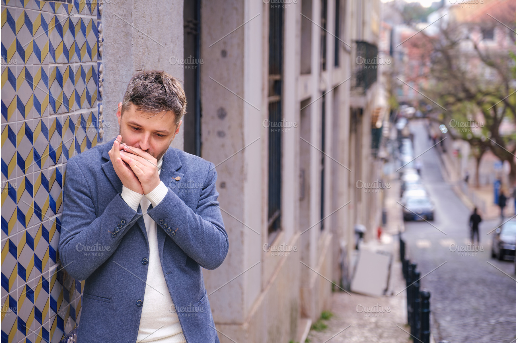 Man plays harmonica outdoors in city, a Person Photo by f9photos