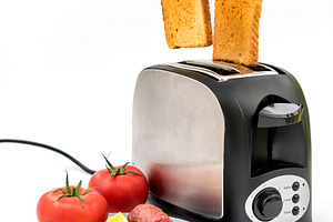 Toasts jumping out of toaster containing appliance, bakery, and bread