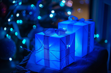 Two elegantly wrapped blue presents, a Photo by Tanuart