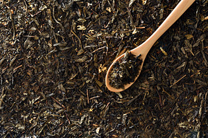 Wooden spoon filled with tea leaves on background tea top, a Food & Drink Photo by Davizro's Market
