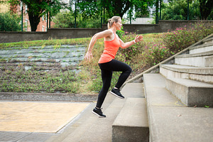 Woman running up outdoor stairs during fitness training session, a Sports & Recreation Photo by etorres69