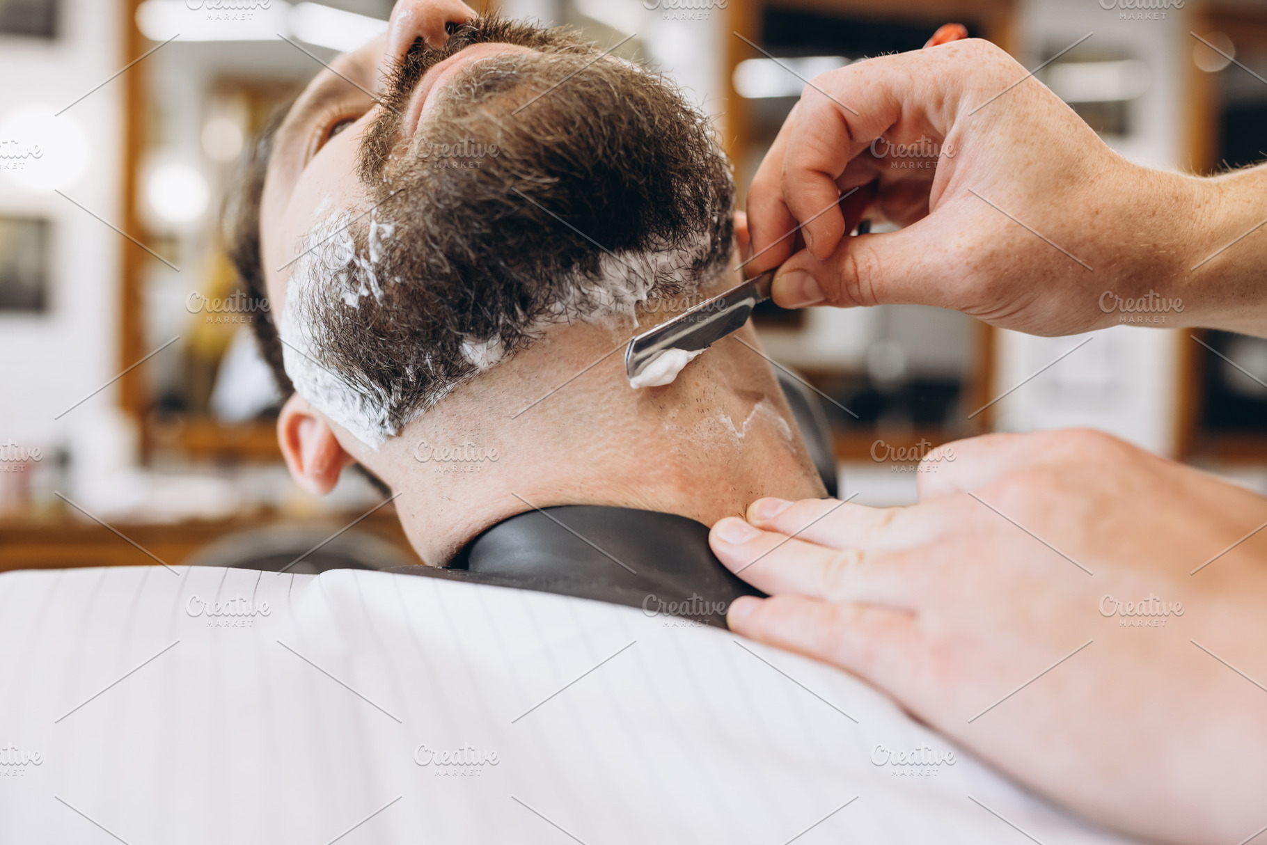 Man getting haircut at the barbershop. Professional barber at work process. Bea, a Person Photo by Volodymyr Melnyk