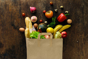 Paper bag of different health food featuring grocery, health, and top