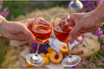 Wine in glasses is held by a woman, a Person Photo by yanadjana