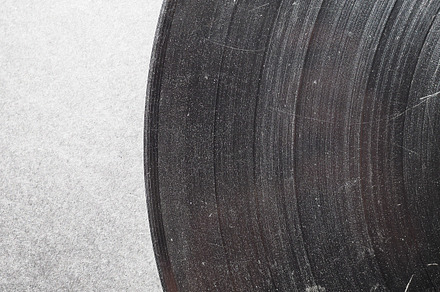 Scratched vinyl record featuring grunge, damage, and pop, a Technology Photo by WorldPhotos