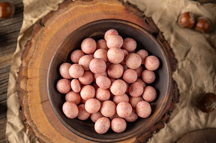 Bowl of raspberry flavour white chocolate covered hazelnuts, a Photo by Grafvision photography